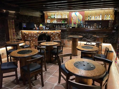 a restaurant with wooden tables and chairs and a bar at PASEO REAL HOTEL BOUTIQUE in Uruapan del Progreso