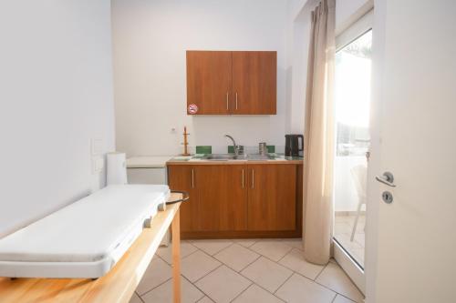 a small kitchen with a bed and a sink at Infinity Wellness Boutique Hotel in Afráta