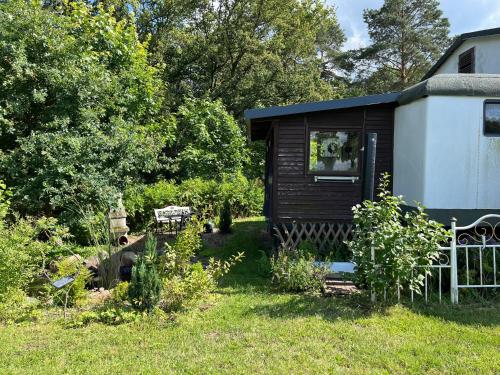 a small cabin in the yard of a house at Tiny House in Mellen