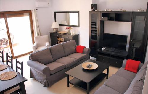 a living room with a couch and a tv at 3 Bedroom Awesome Home In Nerja in Nerja