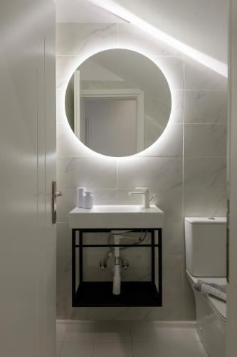 a bathroom with a sink and a mirror at ASTERIA PEARL VILLA 2 with Rooftop Jacuzzi in Tigaki