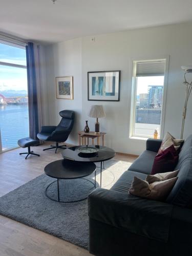 a living room with a couch and a table at Svolvær Havn Apartments in Svolvær