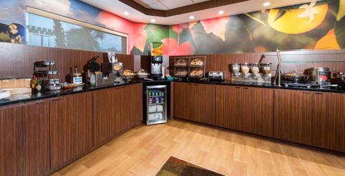 a restaurant with a kitchen with a counter top at Rodeway Inn in Pensacola