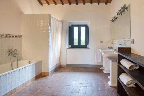 a bathroom with a tub and a sink at Private Chianti Hill Residence in Vagliagli