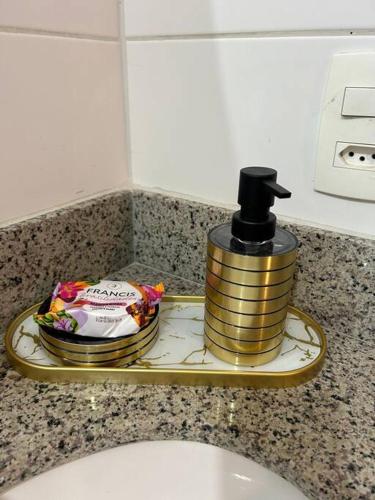 a soap dispenser sitting on a bathroom sink at Pôr do Sol DF Plaza in Brasília