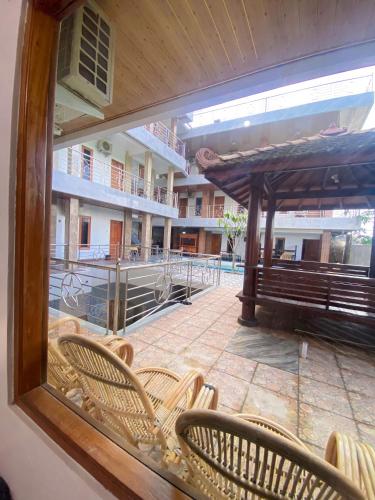 a view of a patio with chairs and an umbrella at Hotel Wijaya family 2 in Yogyakarta
