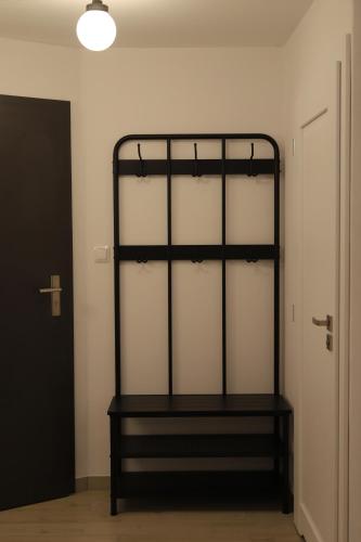 a black shelf in a room next to a door at Solaris-Winnica Hanna in Radomierzyce