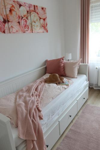 a bedroom with a bed with a flower painting on the wall at Tündér Villa in Balatonfüred