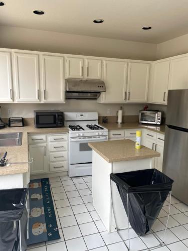 a kitchen with white cabinets and white appliances at Master Bedroom inside a Gorgeous Home in a Beautiful Neighborhood in Las Vegas