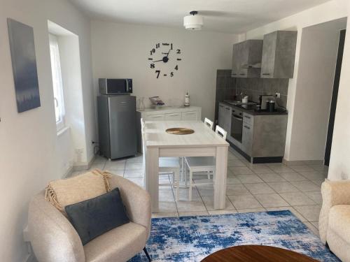 a kitchen with a white table and a kitchen with a refrigerator at La casa sul lago in Lenno