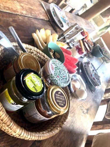 a basket filled with jars of food on a table at El refugio in Reynès
