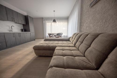 a living room with a couch and a table at Villa MARIKA plus in Alajõe