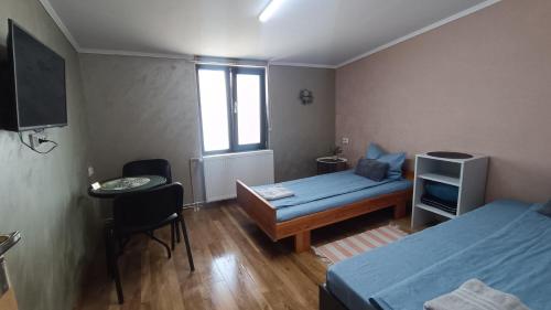 a small room with a bed and a desk and a window at Agape Speranta 96 in Piteşti