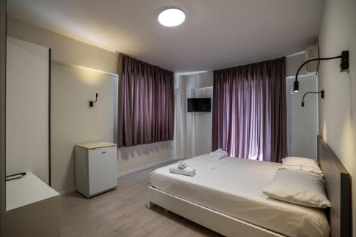 Postel nebo postele na pokoji v ubytování Meraki Hotel