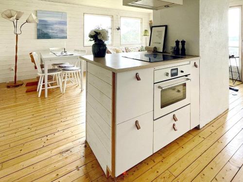 a kitchen with an island with an oven and a table at 4 star holiday home in Uddevalla in Uddevalla