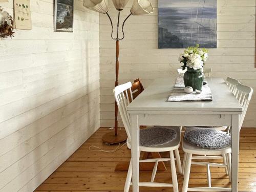 a dining room table with two chairs and a lamp at 4 star holiday home in Uddevalla in Uddevalla
