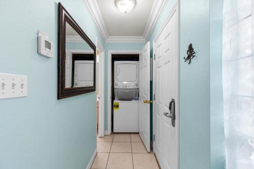 a hallway with a mirror and blue walls at Little Get-Away By The Beach ,Moondancer in South Padre Island