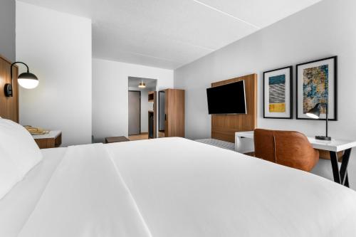 a hotel room with a large bed and a desk at Comfort Inn & Suites York North in York
