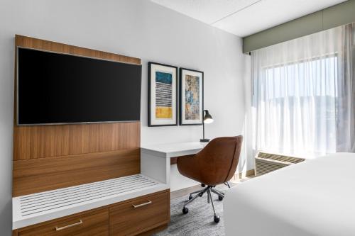 a room with a tv and a desk and a chair at Comfort Inn & Suites York North in York
