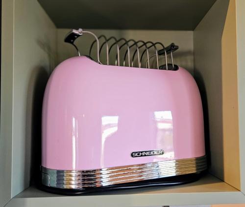 a pink toaster sitting on top of a shelf at Taunusblick in Bad Camberg