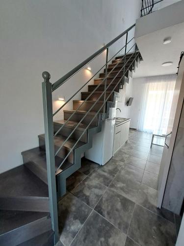 a staircase in a house with a tile floor at Apollon Luxury Rooms in Nea Vrasna