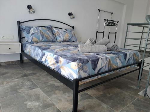 a bed in a room with at Apollon Luxury Rooms in Nea Vrasna