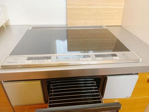 a kitchen with a stove top oven with a counter top at 颯House5 in Osaka