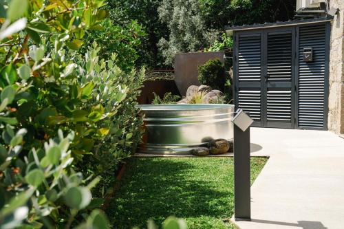 a garden with a bucket of vegetables on the grass at ALTAMENTE - Alojamento Local in Viana do Castelo