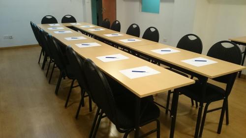 a long row of tables in a room with chairs at Hotel Plaza Roma in Buenos Aires