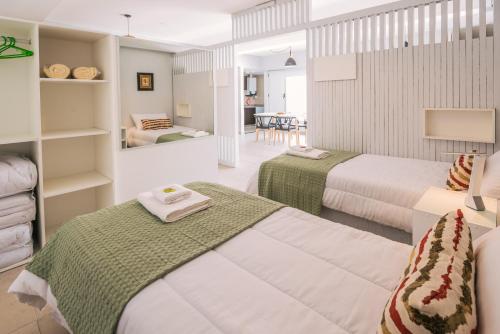 a hotel room with two beds and a table at Gente del Sur - Towers in Ushuaia