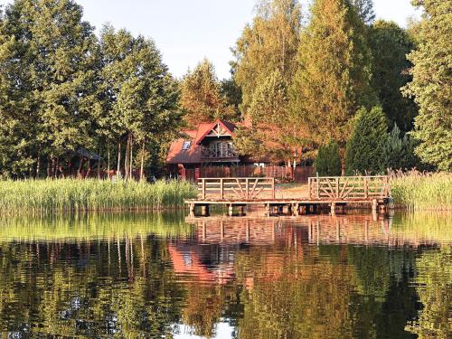 a house on the shore of a lake with a dock at CzillasOrle luksusowy dom nad samym brzegiem jeziora Orle koło Augustowa in Płaska