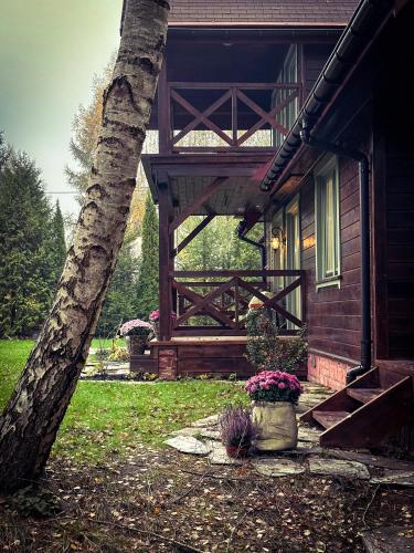 a porch of a house with a wooden deck at CzillasOrle luksusowy dom nad samym brzegiem jeziora Orle koło Augustowa in Płaska
