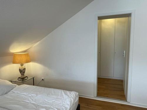 a bedroom with a bed and a sliding door at Große Loft- Wohnung Glück im Grünen in Rösrath