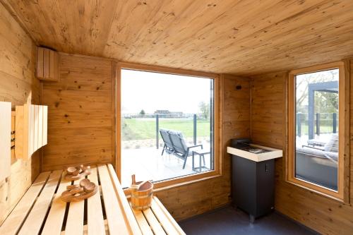 a wooden cabin with a bench and a window at Kells Appartements in Klink