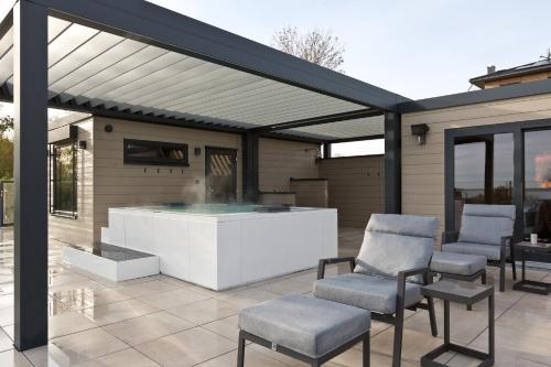 a pavilion with chairs and a table on a patio at Kells Appartements in Klink