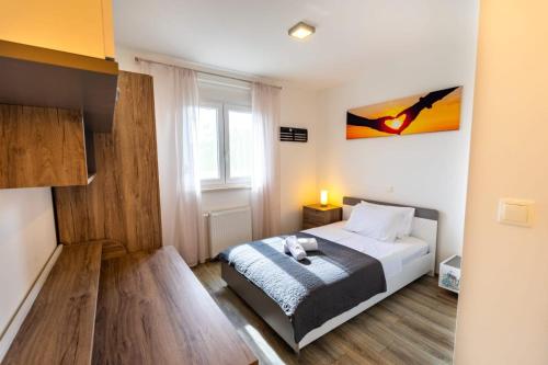 a small bedroom with a bed and a window at Villa Wild Rose in Imotski