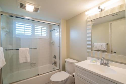 a bathroom with a shower and a toilet and a sink at Serene Lakeview Retreat 3BR Villa Beach Access in Pawleys Island