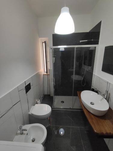 a bathroom with a toilet and a sink and a shower at Oniria Suite - 100 mt dal mare in Terracina