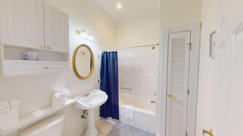 a white bathroom with a sink and a shower at Four Bedroom, Three Bath, Golf Villa, Scenic View in Pawleys Island