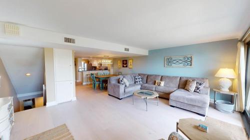 a living room with a couch and a table at CoastalRetreat Beachfront 3BR Litchfield By theSea in Pawleys Island