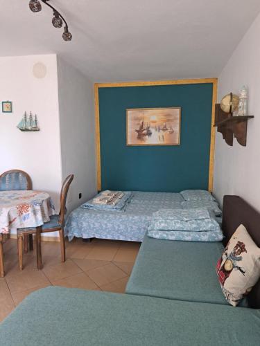 a bedroom with a bed and a table and a table and a bed at Villa Anastasia in Sinemorets