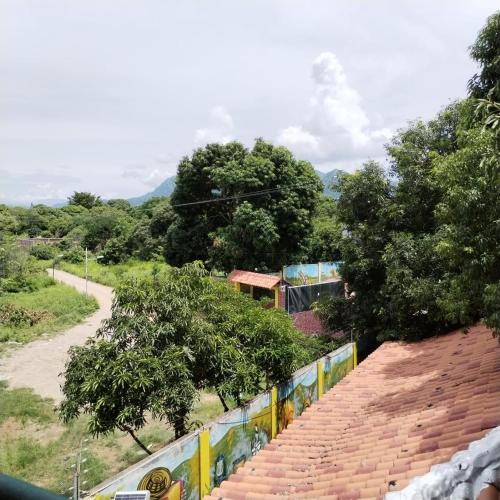 a view of a road with a fence and trees at Hotel El Bosque Valledupar in Valledupar