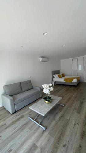 a living room with a couch and a table at Casa Santyana in Amarante
