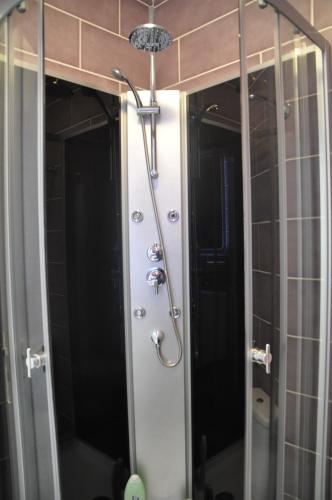 La salle de bains est pourvue d'une douche et de 2 miroirs. dans l'établissement Maison Familiale dans le Domaine de la Plage avec Piscine Privée, à 200m de la Mer, à Valras-Plage