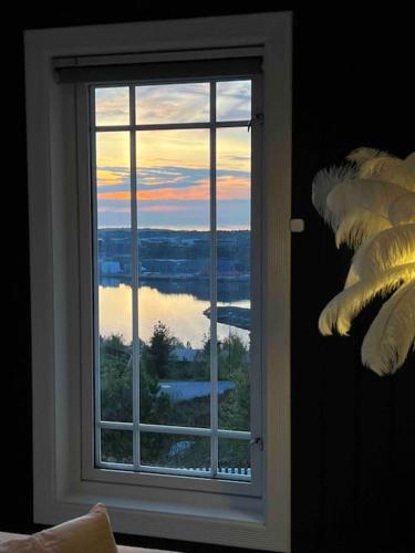a window in a room with a view of the water at Villa Freya with stunning sea view in Kristiansund
