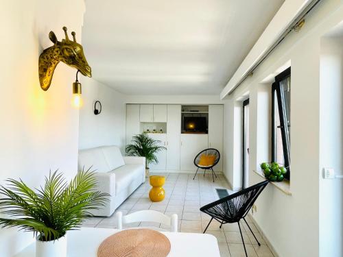 a living room with a giraffe head on the wall at Studio Square - zonrijke studio - zuidgericht balkon - dichtbij strand in Middelkerke