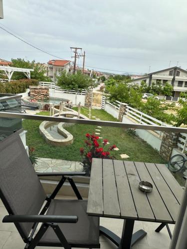 a balcony with a table and a view of a yard at Villa Nikiti View in Nikiti