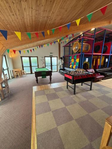 a room with a ping pong table and colorful flags at Seaview Holiday Park in Penzance