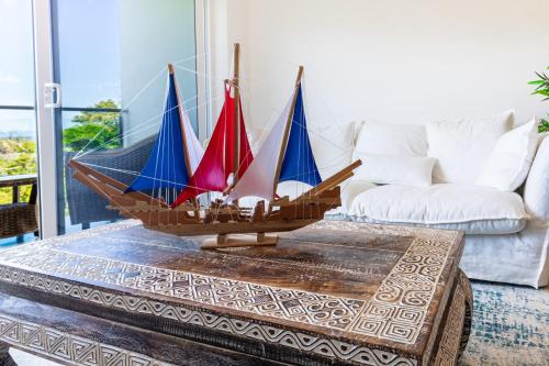 a model boat on a coffee table in a living room at Deluxe Apt with Ocean View & Beach Access only 1 hour drive from San Jose in Puntarenas