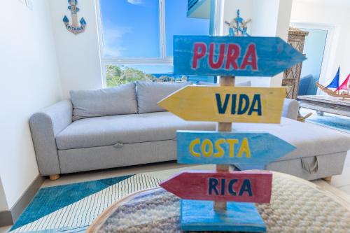a living room with street signs on a table at Deluxe Apt with Ocean View & Beach Access only 1 hour drive from San Jose in Puntarenas